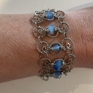 (2/$10) Intricate silver bracelet with 7 blue cats eye beads